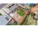 Aerial view of home featuring a spacious backyard with a deck, a patio, and mature trees at 741 Cortez St, Denver, CO 80221