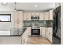 The kitchen features white cabinets, granite countertops, and stainless steel appliances at 741 Cortez St, Denver, CO 80221