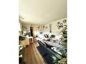 Bright living room with hardwood floors, lots of plants and bright light from windows at 10702 E Exposition Ave # 101, Aurora, CO 80012