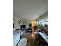 Bright living room with hardwood floors, lots of plants and bright light from windows at 10702 E Exposition Ave # 101, Aurora, CO 80012