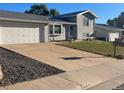 Inviting home featuring a spacious driveway leading to an attached garage and a neatly landscaped lawn at 3097 W 134Th Way, Broomfield, CO 80020