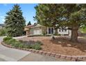 Charming single-Gathering home featuring stone accents, a two-car garage, and a beautifully landscaped front yard at 7466 E Long Cir, Centennial, CO 80112