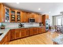 Gourmet kitchen boasting custom wood cabinets, granite countertops, and stainless steel appliances at 10156 Nottingham Dr, Parker, CO 80134