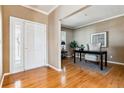 Inviting home office featuring hardwood floors, a white front door and stylish decor at 10156 Nottingham Dr, Parker, CO 80134