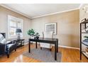This home office features hardwood floors, stylish decor and neutral paint at 10156 Nottingham Dr, Parker, CO 80134