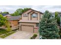 Traditional two-story home featuring a well-kept lawn and attached two-car garage at 10191 Sagecrest St, Highlands Ranch, CO 80126