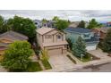 Inviting two-story home showcasing a well-manicured lawn and attached two-car garage at 10191 Sagecrest St, Highlands Ranch, CO 80126