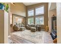 Bright and spacious living room with high ceilings, large windows, and modern flooring at 10191 Sagecrest St, Highlands Ranch, CO 80126