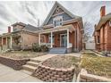 Attractive brick home with a welcoming front porch, perfect for relaxing outdoors at 3833 Umatilla St, Denver, CO 80211