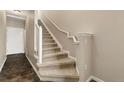 Carpeted staircase with white railing and trim leading to the upper level of the home at 8571 Gold Peak Dr # C, Highlands Ranch, CO 80130