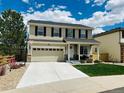 Attractive two-story home boasting a manicured front yard, attached garage, and charming curb appeal at 16893 Trail View Cir, Parker, CO 80134