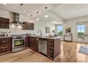 Modern kitchen with stainless steel appliances, granite countertops, and hardwood floors at 410 Acoma St # 518, Denver, CO 80204