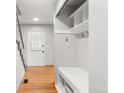 Hallway with hardwood floors, stairs and a coat rack with bench and storage at 15909 E Ford Pl, Aurora, CO 80017