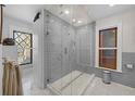 Modern bathroom with frameless glass shower, subway tile, and marble flooring at 1351 N Franklin St, Denver, CO 80218