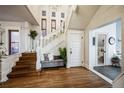 Welcoming foyer with hardwood floors, elegant staircase, and decorative chandelier at 1351 N Franklin St, Denver, CO 80218
