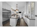 Bright kitchen featuring white cabinetry, stainless steel appliances, and center island with seating at 1351 N Franklin St, Denver, CO 80218