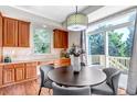 Bright dining area with wood floors, wood cabinets and sliding glass doors to the deck at 10646 Amesbury Way, Highlands Ranch, CO 80126