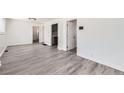 Bright living room with new gray flooring, white walls, and modern trim, offering a spacious feel at 1537 Xenia St, Denver, CO 80220