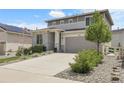 Attractive home showcasing a two-car garage, stone veneer, and lush landscaping at 1886 Makley Loop, Castle Rock, CO 80104