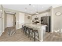 Modern kitchen with a large granite island, stainless steel appliances, and stylish pendant lighting at 1886 Makley Loop, Castle Rock, CO 80104