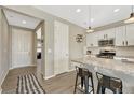 Bright kitchen features white cabinets, stainless appliances, and a convenient breakfast bar at 1886 Makley Loop, Castle Rock, CO 80104