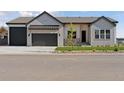 Charming single-Gathering home with well-manicured lawn, three-car garage, and inviting covered porch at 1425 Burt Ave, Berthoud, CO 80513