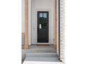 Stylish black front door with glass panels and a welcoming wreath, framed by wood columns and brick accents at 1425 Burt Ave, Berthoud, CO 80513