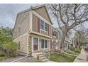 Charming multi-story townhome featuring a stone foundation, vertical siding, and inviting front steps at 1240 S Idalia St, Aurora, CO 80017