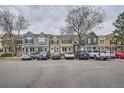 A row of colorful townhomes are lined up along the street, with ample parking in front at 1240 S Idalia St, Aurora, CO 80017