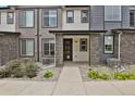Charming townhome exterior featuring stone pillars, neutral siding, covered porch, and a well-maintained walkway at 19733 W 93Rd Ln # D, Arvada, CO 80007