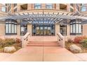 Inviting entrance to Penterra Plaza, showcasing the covered walkway, manicured landscaping, and grand doorway at 8100 E Union Ave # 310, Denver, CO 80237
