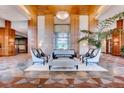 An elegant lobby featuring comfortable seating, stylish decor, wood accents, and a serene water feature at 8100 E Union Ave # 310, Denver, CO 80237