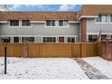 Charming townhouse with wood fence, and brick accents; covered in fresh snow at 2016 W 101St Ave, Thornton, CO 80260