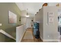 Inviting hallway features wood floors, a decorative painting, and a sign that reads 