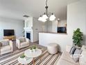 Bright, staged living room featuring modern furnishings and an open floor plan at 12713 Leyden St # E, Thornton, CO 80602