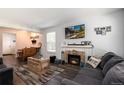Comfortable living room featuring a fireplace, modern furniture, and wood-look floors at 1537 S Owens St # 31, Denver, CO 80232