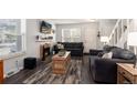 Inviting living room with a fireplace, wood-look floors, and cozy seating arrangement at 1537 S Owens St # 31, Denver, CO 80232