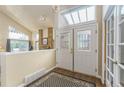 Spacious foyer with high ceilings, skylight, beautiful wood floors, and a stylish rug at 262 Yank Ct, Lakewood, CO 80228