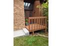 Charming entryway with a raised wooden deck, brick accents, and a welcoming front door at 262 Yank Ct, Lakewood, CO 80228