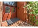 Inviting front door with glass panels, complemented by a blooming decorative tree at 262 Yank Ct, Lakewood, CO 80228