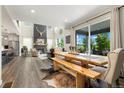 Inviting living space featuring a dining area, fireplace, seamless indoor-outdoor flow, and plenty of natural light at 800 Meadowlark Dr, Erie, CO 80516