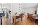 Bright, open-concept space with hardwood floors, seamlessly connecting to the kitchen at 6671 Chase St, Arvada, CO 80003