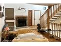 Spacious living room with a stone fireplace and stairs to the second floor at 6836 W 84Th Cir # 15, Arvada, CO 80003