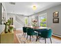 Bright dining room with hardwood floors, stylish furniture, and natural light at 3330 E Tennessee Ave, Denver, CO 80209
