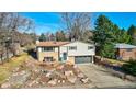 Inviting two-story home with a well-maintained lawn and a two-car garage at 6742 Flower St, Arvada, CO 80004