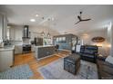 Spacious open-concept living room with vaulted ceilings, hardwood floors, and seamless flow into the modern kitchen at 11785 W Belleview, Littleton, CO 80127