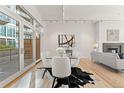 Elegant dining area featuring a glass table, plush chairs, and plenty of natural light from sliding glass doors at 1644 Little Raven St, Denver, CO 80202