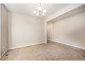 Carpeted living room with neutral paint, bright light, and open access to other rooms at 21383 E Smoky Hill Rd, Centennial, CO 80015