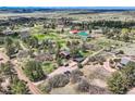 This aerial image shows the property, outbuildings, and the surrounding rural neighborhood at 7715 Rafter Rd, Franktown, CO 80116