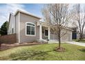 Charming one-story home with a manicured lawn and inviting front porch at 9640 Sydney Ln, Highlands Ranch, CO 80130